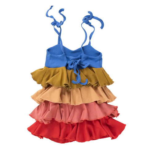 The Girls Twirl Dress by Spiritex | Sustainable Apparel features a sleeveless rainbow design with blue tie straps, blue bodice, and four ruffled skirt layers in olive green, peach, pink, and red. Made from organic cotton and shown flat on a white background.