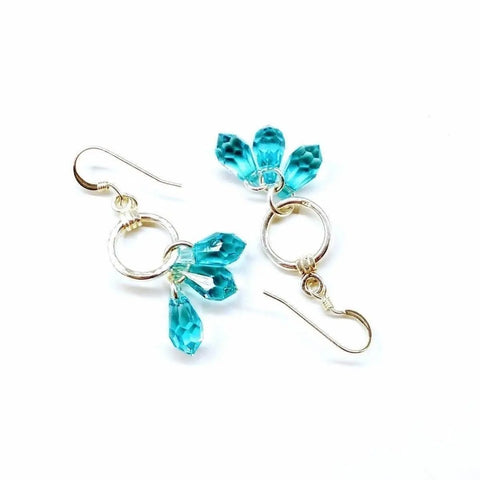 Sterling Silver Hammered Aqua Crystal Cascading Drop Earrings by Alexa Martha Designs feature three faceted blue teardrop beads in a cluster and are shown on a white background.