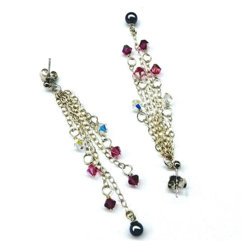 The Long Sterling Silver Crystal Pearl Tassel Earrings by Alexa Martha Designs feature handmade fringe with silver chains, pink, blue, and clear beads, plus a black bead tip, displayed on a white background.