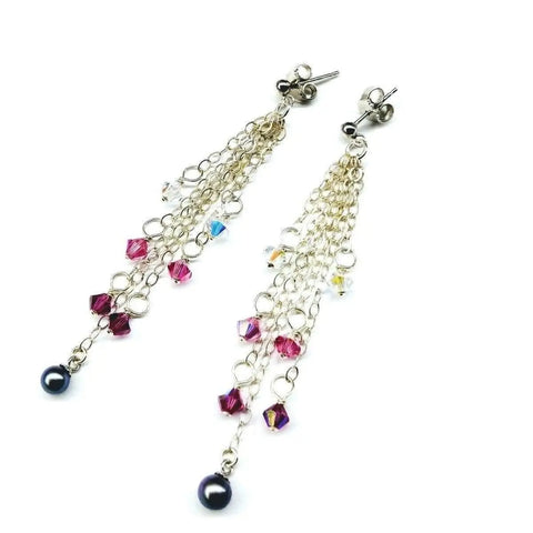The Long Sterling Silver Crystal Pearl Tassel Earrings by Alexa Martha Designs feature small pink and clear crystal beads with a dark pearl at the tip, elegantly displayed on a white background.