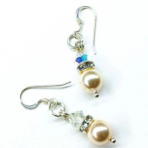 Alexa Martha Designs Silver Swarovski Crystal Pearl Stack Earrings feature cream pearls, clear and blue crystals, and silver hooks with decorative accents. Displayed on a white background.