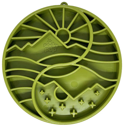 The SodaPup Sun and Moon Design ETray is a green, round silicone slow feeder tray for smaller dogs, featuring raised mountains, sun shapes, wavy lines, stars, and embossed branding—ideal for enrichment and slowing feeding.