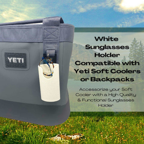A Chatelet Manufacturing Sunglasses Holder Attachment is secured to a gray Yeti soft cooler, holding sunglasses. It’s compatible with Yeti coolers & backpacks with straps, and made in the USA. Nature scene in background.