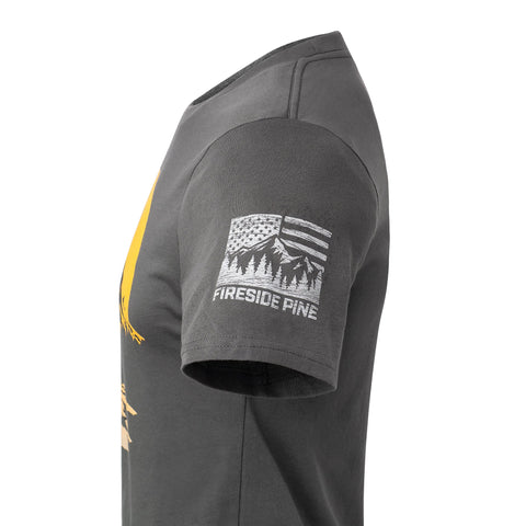 A side view of a dark gray short-sleeve Sunrise Hiker t-shirt by Fireside Pine, made in the USA, with a white sleeve graphic: a stylized US flag above pine trees and the FIRESIDE PINE text.