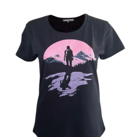 The Fireside Pine Sunrise Hiker (W) is a black T-shirt made from breathable fabric, featuring a graphic of a person on a rocky cliff with a pink sun and mountain range in the background.