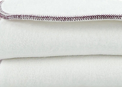 Close-up of two Geffenbaby Super Absorbers Plus Cloth Diaper Inserts, neatly folded to display their soft, plush texture and excellent absorbency.