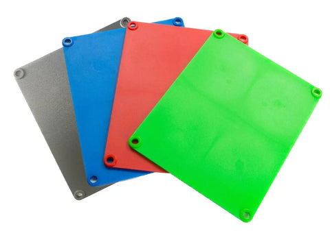 Four rectangular Supplement Cutting Boards by Karving King in metallic gray, blue, red, and green are stacked and fanned out. Each BPA-free, non-slip silicone mat features a hole in every corner.