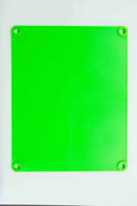 The Karving King Supplement Cutting Board is bright green, translucent, BPA-free, with a matte finish, rounded corners, and a circular hole near each corner. It is shown on a white background.