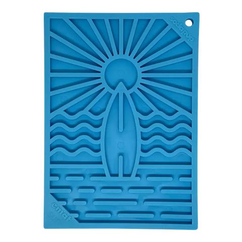 The Surfs Up Small Dog Lick Mat by SodaPup is a blue silicone interactive slow feeder with a surfing design—perfect for mealtime enrichment and fun; proudly made in the USA.