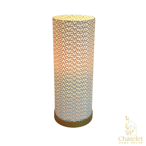 The Surface Beam Lamp by Chatelet Manufacturing features a cylindrical white design with a perforated, patterned surface atop a round wooden base, offering warm, ambient color-changing lighting—perfect for night stands or coffee tables.