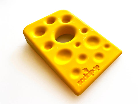 The SodaPup Swiss Cheese Wedge EChew is a durable yellow nylon dog chew toy shaped like Swiss cheese with holes, perfect for power chewers and ideal as an enrichment toy.