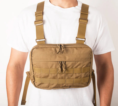 A person models the MIS Chest Rig - Coyote Brown, made from durable Cordura Nylon, featuring adjustable straps and multiple zippered compartments over a plain white t-shirt.