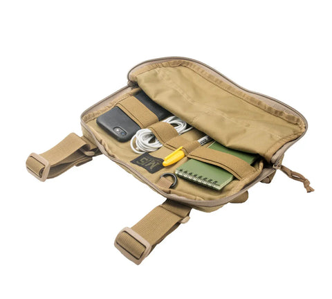 The MIS Chest Rig - Coyote Tan, made from water-resistant Cordura Nylon, is unzipped to reveal a phone, white earphones, yellow pen, green spiral notebook, and key tag—each neatly secured by elastic straps.