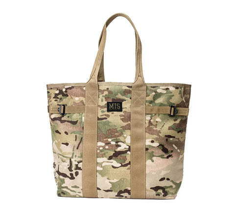 The MIS Multi Tote Bag - Multi Cam features camouflage Cordura Nylon, tan handles and straps, a rectangular front MIS patch, water-resistant design, and black side buckles for extra functionality.
