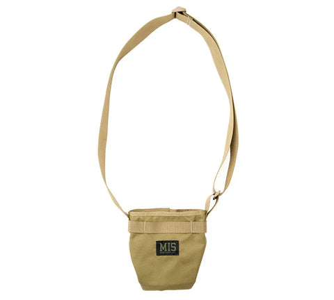 The MIS AB Shoulder Pouch in Coyote Tan is a small, water-resistant Cordura nylon crossbody bag with an adjustable strap and a front patch featuring MIS in yellow and green letters.