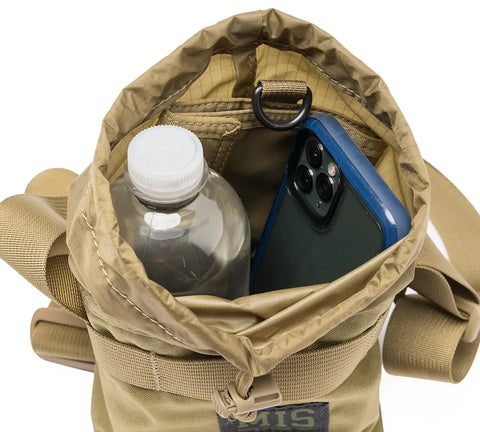 The MIS AB Shoulder Pouch - Coyote Tan, made in the USA, is shown from above holding a clear water bottle and blue smartphone. This Cordura nylon bag features a textured interior, metal ring, sturdy straps, and is water-resistant.
