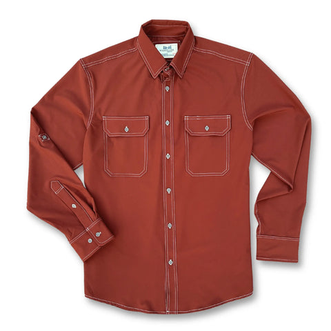 The Nash Button Down Shirt - Brick by Wilson Lane Apparel features long sleeves, white contrast stitching, two button-flap chest pockets, and a classic collar. Shirt shown laid flat on a white background.