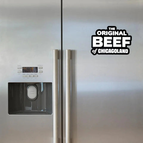 A stainless steel fridge with a water and ice dispenser on the left door features a black and white Chatelet Manufacturing magnet reading the Original Beef of Chicagoland—a decorative gift for fans of TV show The Bear—on the right door.