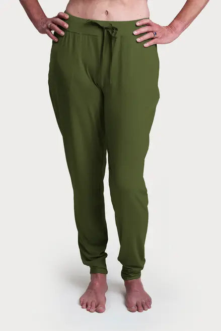 A person stands barefoot against a white background, wearing Goodnighties Jogger Pants in olive green, featuring an adjustable waist tie and side pockets.
