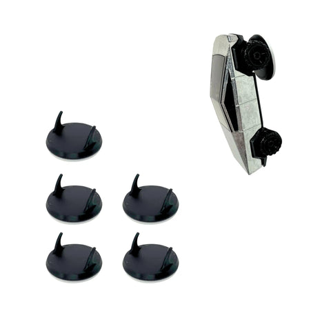 A small silver toy car stands upright next to five round black bases with pegs, showcasing the Chatelet Manufacturing Toy Car Wall Display Organizer—compatible with Hot Wheels and easy to mount on your wall for display and access.
