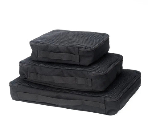 Three black rectangular packing cubes from the MIS Organizer Set, made of durable Cordura nylon, are stacked against a white background.