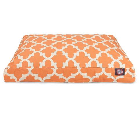 The Trellis Rectangle Dog Bed by Majestic Pet is an orange cushion with a white geometric pattern, a washable cover, and a small brand label on the front lower right corner, shown against a white background.