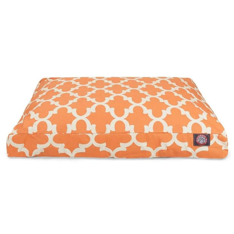 The Majestic Pet Trellis Rectangle Dog Bed features an orange and white geometric pattern, a small dark side label, flat cushioned surface with premium polyester fill, and a washable cover for easy cleaning.