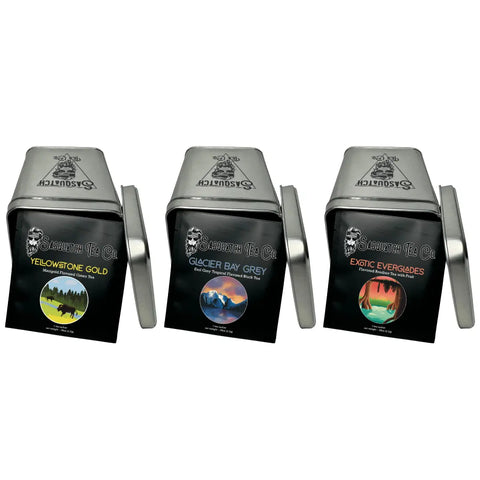 The Tropical Tea Bundle by Sasquatch Tea Co features three silver tins—Yellowstone Gold, Glacier Bay Grey, and Exotic Everglades—with colorful nature designs and includes Earl Grey and green teas.