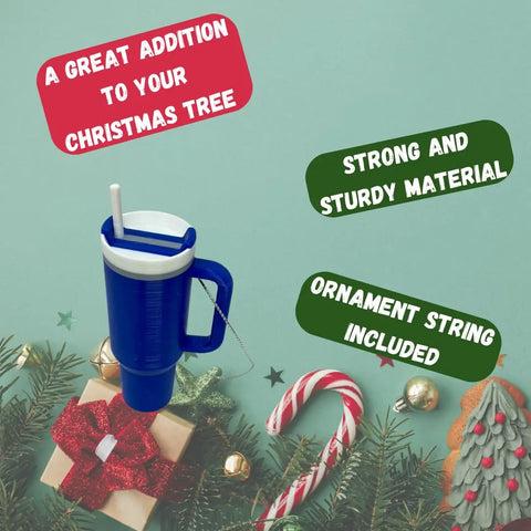 A blue Tumbler Cup Replica Christmas Ornament by Chatelet Manufacturing, featuring a white straw and handle, sits among festive decor. Made in USA with strong material; ornament string included. Perfect for your 2023 holiday tree!.