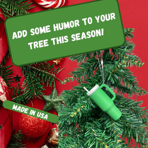 A festive Christmas tree is adorned with Chatelet Manufacturing’s Tumbler Cup Replica Christmas Ornament—2023’s popular water bottle mug ornament, made in USA. Green signs say: “Add some humor to your tree this season!” on a red and green background.