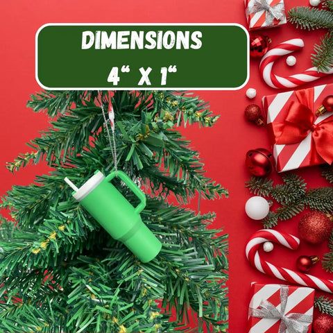 The Chatelet Manufacturing Tumbler Cup Replica Christmas Ornament (2023 popular water bottle mug) hangs on a tree by a DIMENSIONS 4 x 1 sign, with gifts, candy canes, and decorations on a red background. Made in the USA.