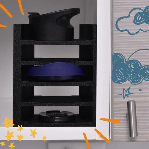 A Chatelet Manufacturing Lid Organizer Rack Compatible with Yeti Rambler & Tumblers neatly stores various lids and metal straws inside a cabinet with playful blue cloud and star doodles on its door, plus orange star accents on the organizer.