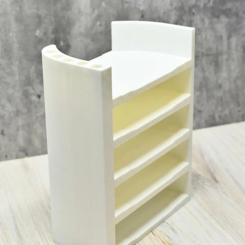 The Chatelet Manufacturing Lid Organizer Rack Compatible With Yeti Rambler & Tumblers holds 5 tumbler lids plus metal straws, and is made in the USA from white plastic. Shown on a light wooden surface with a gray textured background.