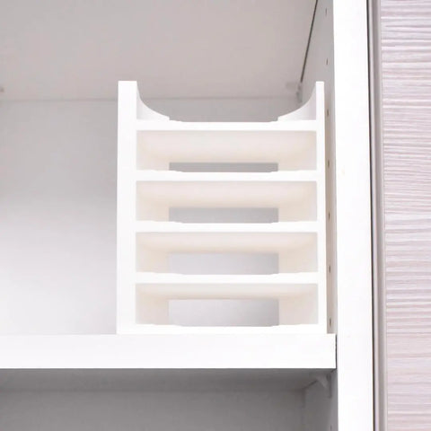 A white Chatelet Manufacturing Lid Organizer Rack (5 slots) sits on a shelf in a white cabinet, ideal for sorting documents or storing Yeti Rambler and tumbler lids plus metal straws. Made in USA.