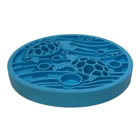 The SodaPup Turtle Emat-Mini Enrichment Lick Mat features a round, blue design with raised sea turtles, waves, and bubbles for an ocean-like look. It includes suction cups for secure placement.