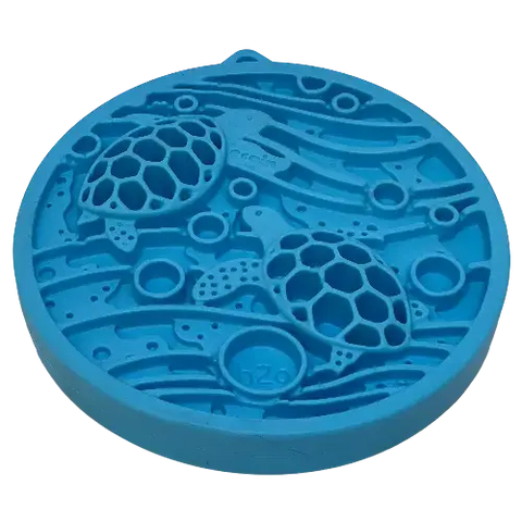 The SodaPup Turtle Emat-Mini Enrichment Lick Mat With Suction Cups is a round, blue silicone mat featuring two raised sea turtle designs with hexagonal shells, surrounded by wavy lines and circles.