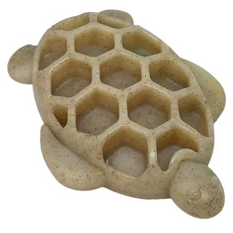 The SodaPup Turtle EChew Durable Nylon Chew and Enrichment Toy is beige, turtle-shaped with a honeycomb shell pattern, and resembles a soap dish or organizer. It’s shown from above on a white background.