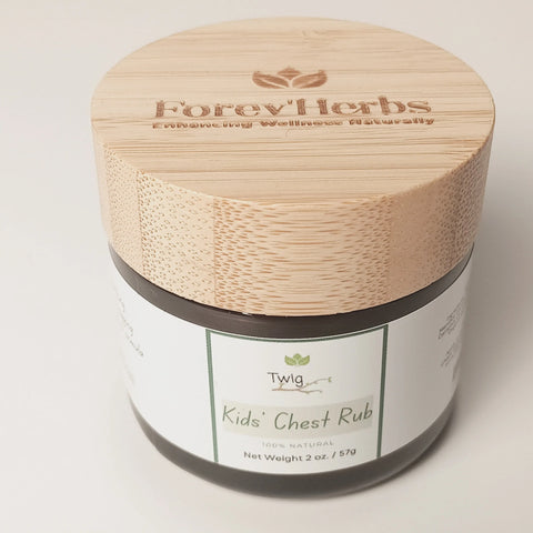 A 2 oz (57g) jar with a wooden lid labeled Forev'Herbs contains Twig - Kids' Chest Rub, a 100% natural chest rub with essential oils, designed for children's wellness.