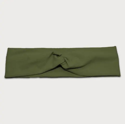The Goodnighties Twist Headband is a wide, olive green, American-made hair accessory with a center twist knot design, crafted from soft, lightweight fabric and shown on a plain white background.
