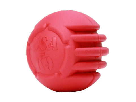 The SodaPup USA-K9 Stars and Stripes Ultra-Durable Rubber Chew Ball is a tough red dog toy for power chewers, featuring grooves for dental care and an embossed logo, shown against a white background.