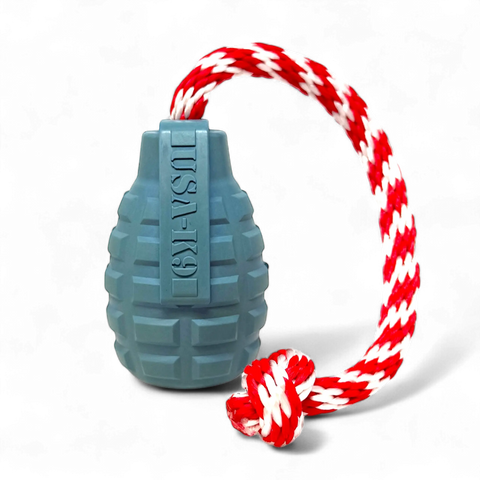 The SodaPup USA-K9 Grenade Durable Rubber Chew Toy in Steel Blue features a red and white braided rope, works as a treat dispenser, tug toy, reward toy, and retrieving toy—perfect for interactive fun.