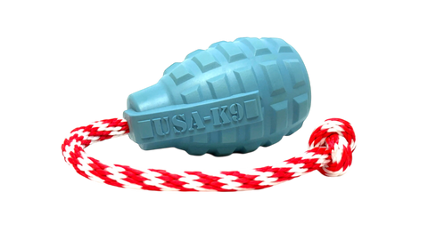 The SodaPup USA-K9 Grenade Durable Rubber Chew Toy in Steel Blue, attached to a red and white braided rope, serves as a treat dispenser, tug, reward, and retrieving toy. The background is transparent.