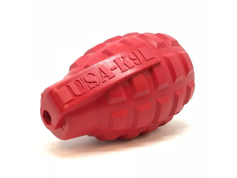 The SodaPup USA-K9 Grenade EDispenser is a red, grenade-shaped durable rubber chew toy and treat dispenser for power chewers, featuring a textured surface with USA-K9 embossed on the side.