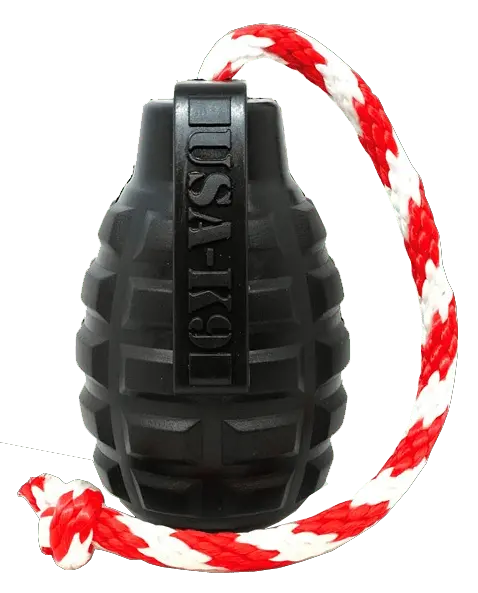 The SodaPup USA-K9 Magnum Grenade is a black, durable rubber chew toy that doubles as a treat dispenser, tug, and retrieving toy. It features “USA-K9” embossing and comes attached to a red and white braided rope.