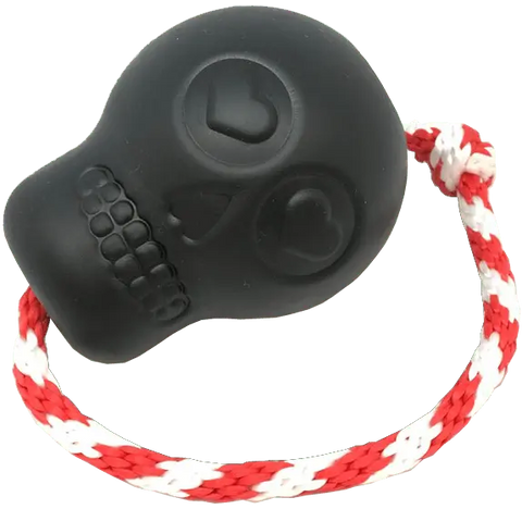 The SodaPup USA-K9 Magnum Skull in black is a durable rubber chew, treat dispenser, tug, and retrieving toy for dogs. It features heart-shaped eye and nose imprints plus a red and white braided rope handle—perfect for playful pups.