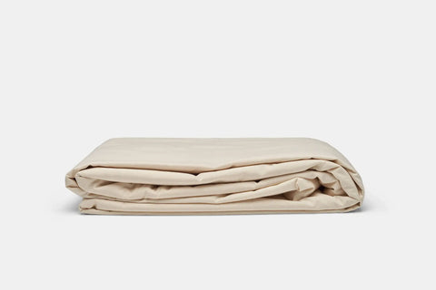 A neatly folded Cotton Percale Bed Sheet Set by American Blossom Linens, made from USA-grown cotton, is displayed on a plain, light gray background.