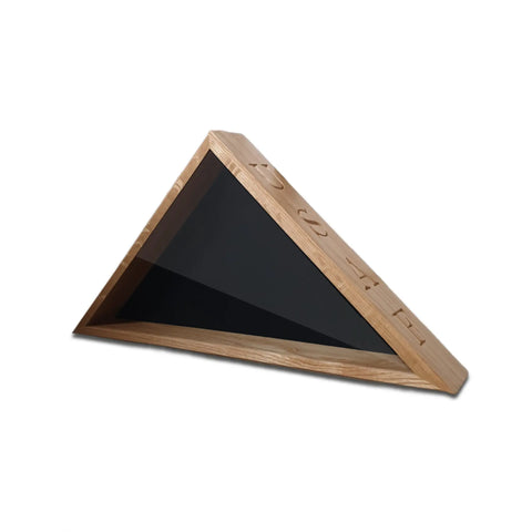 The Legacies of America Woodworking Company’s USAF Oak Burial Flag Display Case (for 5 x 9.5 flag) has a triangular oak design with a black glass or acrylic face, geometric engravings, and is crafted by U.S. Military Veterans.