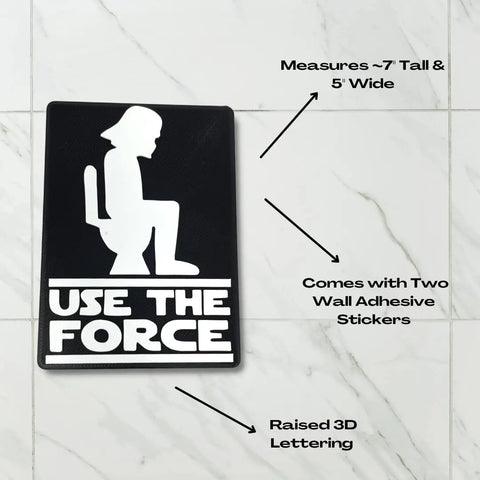 The Use the Force Bathroom Sign by Chatelet Manufacturing is a black and white wall sign with a white helmeted figure on a toilet and USE THE FORCE caption. It includes adhesive stickers, raised 3D lettering, and makes a perfect gag gift or fun wall art.