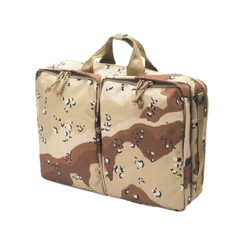 The MIS 3 Way Brief Bag in Chocochip Desert Camo features a rectangular design with two pockets, tan handles, and water-resistant materials, showcased on a white background.