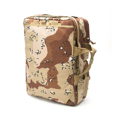 The MIS 3 Way Brief Bag in Chocochip Desert Camo is a rectangular, khaki and brown Cordura Nylon backpack with tan handles and zippers, shown standing upright on a white background.